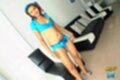 Fa standing beside couch wearing blue shorts