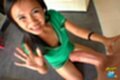 On her knees wearing green dress hand raised spent cock cum on face