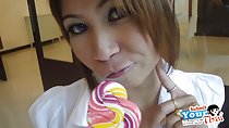 Lollipop raised to her lips