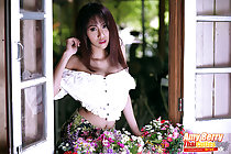 Amy Berry at open window long hair over her bare shoulders
