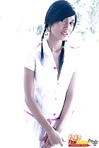 Yoko in white dress hands crossed