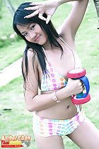 Wearing bikini holding dumbell long hair