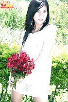 Holding bunch of flowers in see through dress