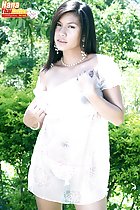Pulling dress from her shoulder wearing pearl necklace