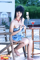 Sandy Ari holding dress up over her breasts bare feet