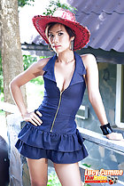 Wearing zipped dress in red hat standing with hand on hip