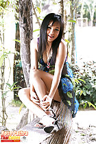 Seated on bench knees drawn up wearing high heels