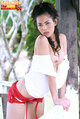 Leaning against fence bare tits wearing red shorts