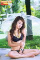 Seated in bra and panties holding transparent umbrella