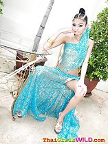 Seated on chair legs open hand on knee wearing high heels