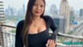 Standing on balcony wearing black dress
